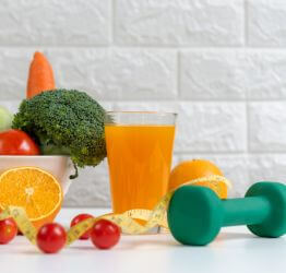 Fruit, vegetables, juice, a tape measure, and hand weight